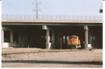 BNSF 7410 emerges from the I-25 overpass as she rolls south to Colorado Springs, Co.